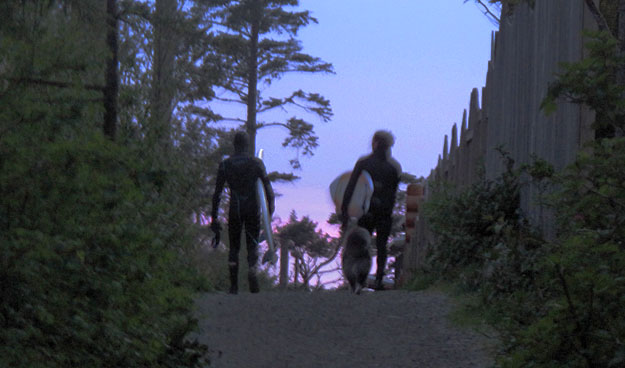 Surfers walking with dog