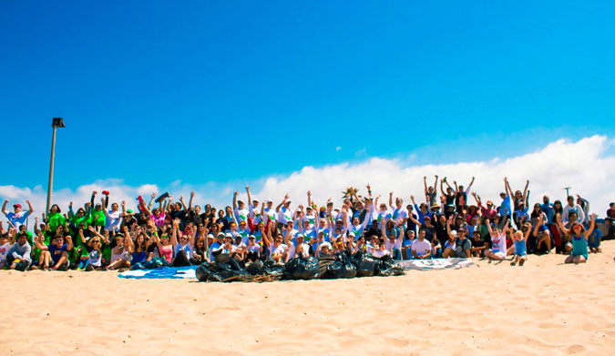 Volunteers cheering after a successful beach cleanup