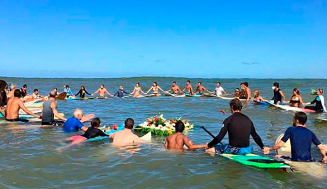 Surfers off the coast of Sayulita, Nayarit, Mexico, link hands during a paddle-out ceremony for Dean Lucas and Adam Coleman. Photo: Facebook/Federacion Mexicana de Surfing