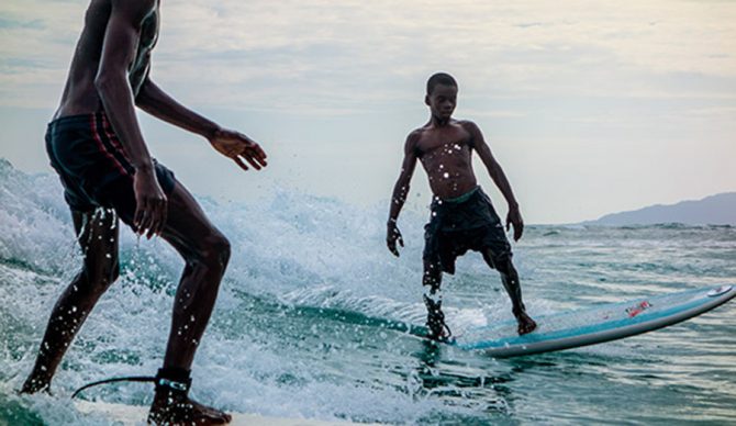 Two of the boys from Surf Haiti dodge share a wave, May 5, 2014.