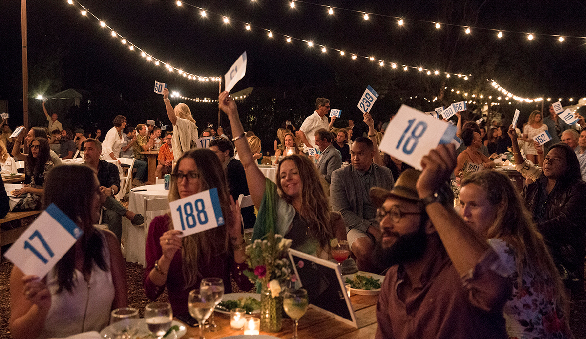 Guests making bids for the Two Coasts : One Ocean live auction.  