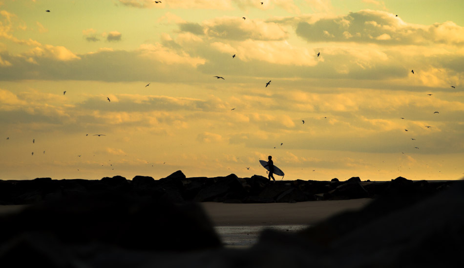 Unknown surfer making his way out for one last ride. Photo: <a href=\"http://christor.photoshelter.com/\" target=_blank>Christor Lukasiewicz</a>