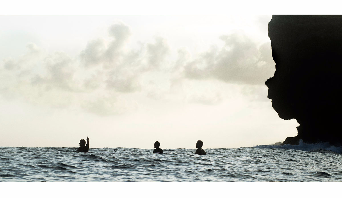 Line-up of surfers with the baby face in the background. Photo: <a href=\"https://instagram.com/alexlaurelphotographie\">Alex Laurel</a>