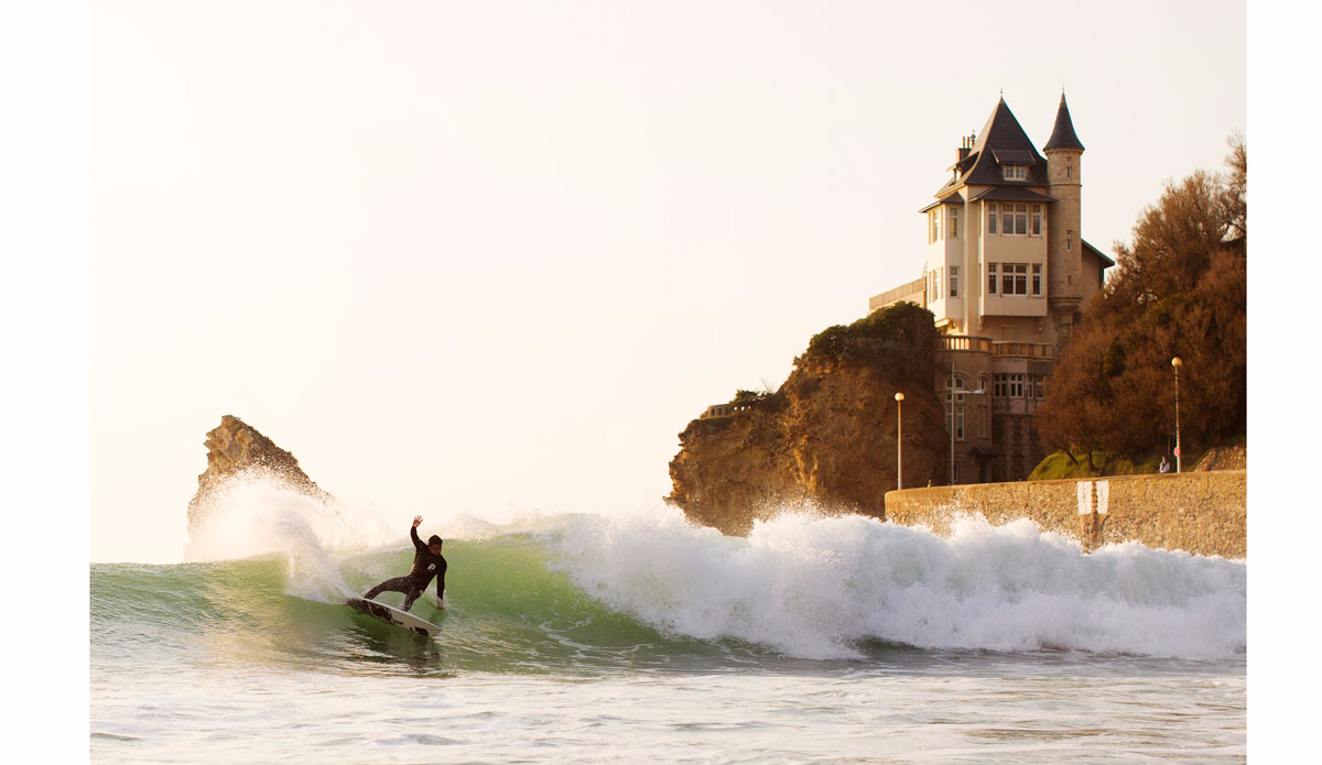 Nothing is better to ride your bike to go to surf – avoiding airplanes and long hours of travel. When you live in Biarritz this is part of the lifestyle. Picture of Tim Boal, former WSL surfer,  in Biarritz with the famous Villa Belza in the background. Photo: <a href=\"https://instagram.com/alexlaurelphotographie\">Alex Laurel</a>