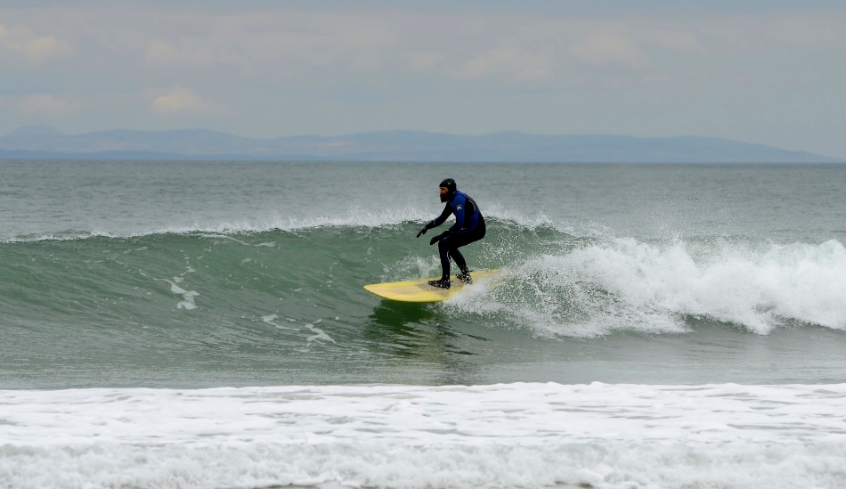 Tommy from Larne, Scotland, in the distance. Whiterocks beach, Portrush. Photo: <a href=\"www.andyhillphotography.com\">Andy Hill</a>