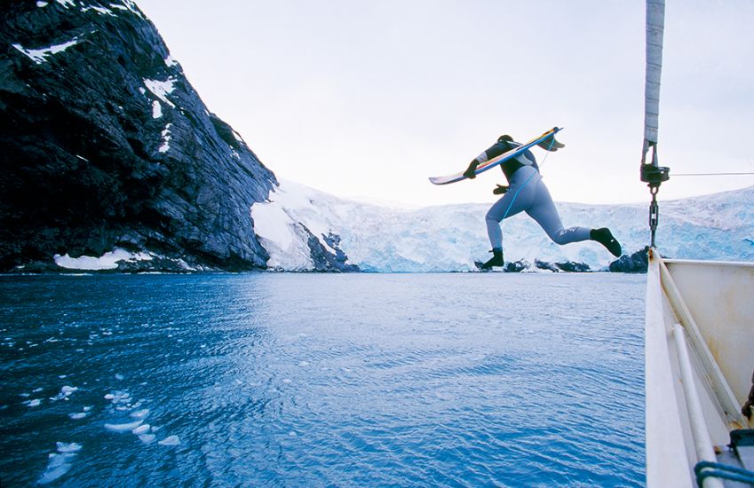 2000. Chris Malloy. Jumping off the boat in Antarctica. Photo: <a href=\"http://www.artbrewer.com\" target=_blank>Art Brewer</a>