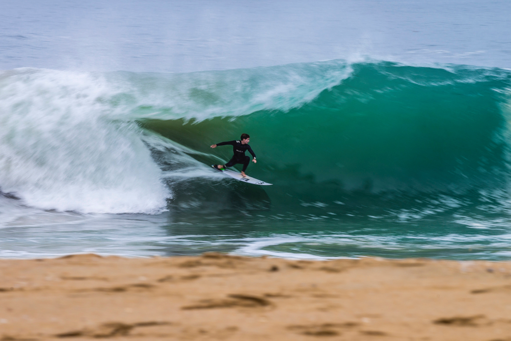 Local grom Parker Cohn catching the side-wave under a heavy lip at the Wedge. Photo: Ben Ginsberg