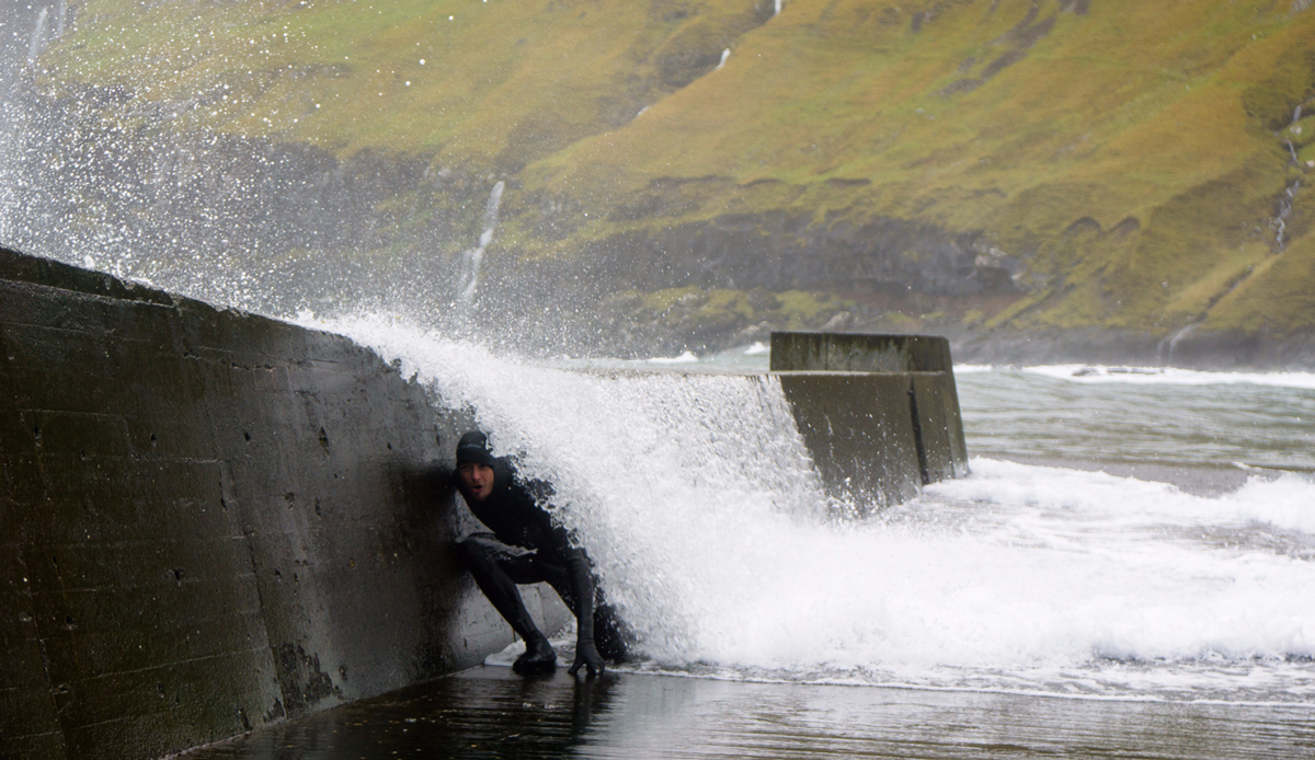 Tyler Warren Getting barreled by storm swell hitting the breakwater in the Faroe Islands. This breakwater also serves as a deck for whaling in the summer. Photo: <a>Chris Burked</a>