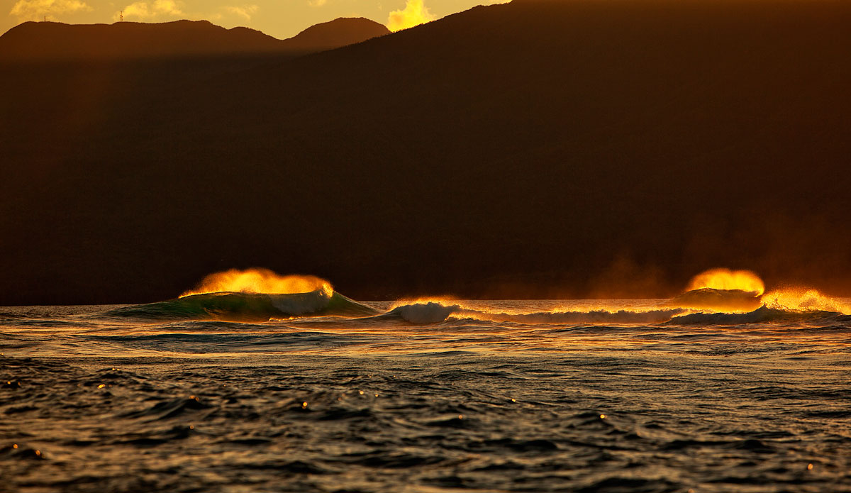  I was surfing on another reef the night before and kept seeing these giant backwash waves bounce 20\' + in the air every 10-20 minutes.  I was surfing with two others and nobody wanted to get out so I could drive over and shoot this spectacular event across the way.  The next afternoon we went back out to surf and I asked the boys if we could get out of the water 10 minutes before the sun set and zip over to find this backwash wrap of a wave phenomena.  It worked out.   Photo: <a href=\"http://www.bobridges.com/\">Bo Bridges</a>