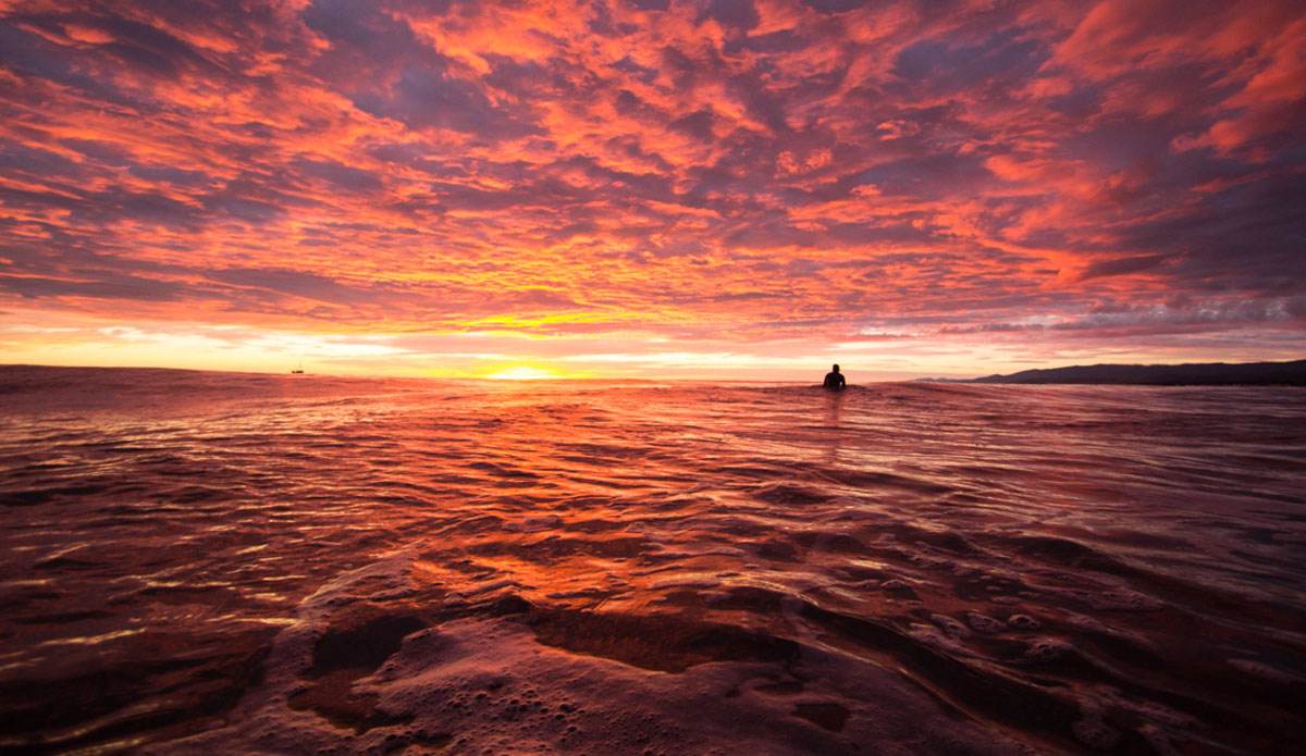 Everyone has a sunset picture.  The surfer in this picture let a set roll through because he was blown away by the sunset... so was I. Photo: <a href=\"http://www.kincaidcliffordphotography.com/\"> Brian Clifford</a>