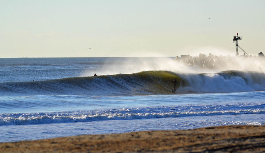 Surfers catching some green shade in the middle of below-freezing January. Charlie Mills getting stoked on an epic wave to realize in ten seconds, he will snap his board on this monster. It seems like it was worth the ride to lose a board on the journey. Photo: Chris Centrella