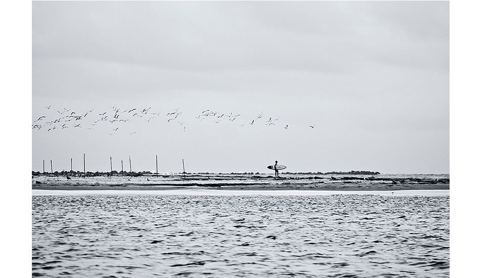 Morning Commute: 2011 Wrightsville Beach, NC. Local surfer contemplating his paddle across sharky waterway. On this day, it was worth the paddle. Photo: <a href=\"http://www.chrisfrickphotography.com/\" target=_blank>Chris Frick</a>.