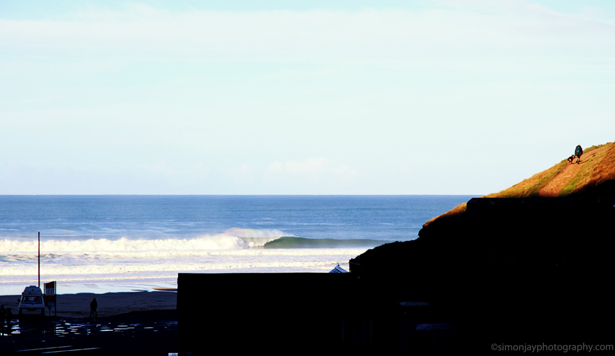 Dog walker and perfect left. Always wonder whether walkers, hikers, beach goers are as interested as me in the stunning waves breaking in front of them. Photo: <a href=\"https://plus.google.com/102308141752801627777/posts\"> Simon Rickwood</a>