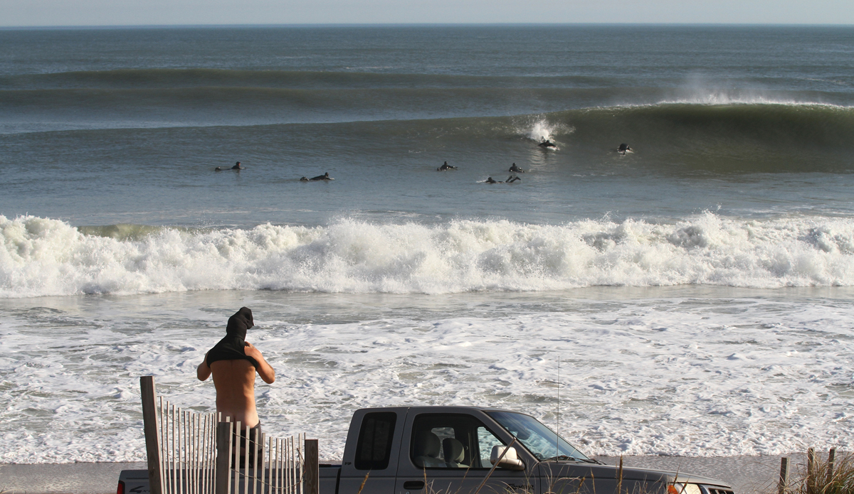 Not many beach towns let you drive on their beaches. However, October through May you can on North Carolina\'s Outer Banks. Here, Craig Watson rubbers up for Jonas at K street in Kill Devil Hills Avalon area. Photo: Mickey McCarthy