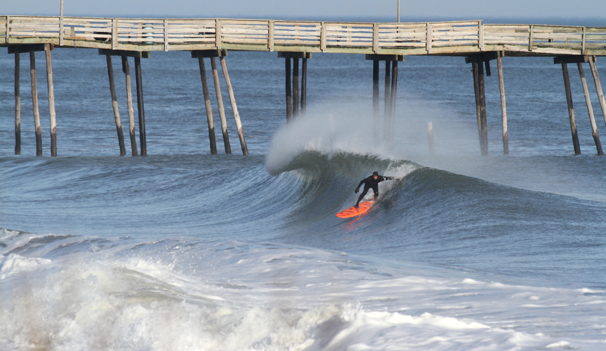 A beat up Avalon pier provides a backdrop for Ricky Miller as he puts his foamy in the face of this drainer. Photo: Mickey McCarthy