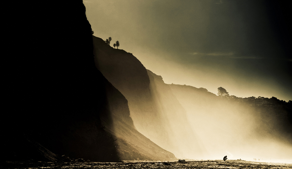 I believe this is Tim Tebow just moments before paddling out at Blacks Beach. One of those days when the mist from the waves get pushed against the cliffs to make for some dramactic light. Easily one of my favorite beaches in the world. Photo: <a href=\"http://9mphoto.com/\" target=_blank>Myles McGuinness</a>