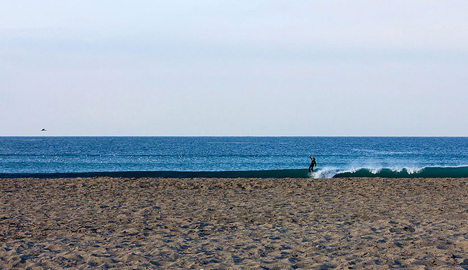 Unknown longboarder enjoying the early morning solitude. Photo: <a href=\"http://www.gagehingeley.com/\" target=_blank>Gage Hingeley</a>.