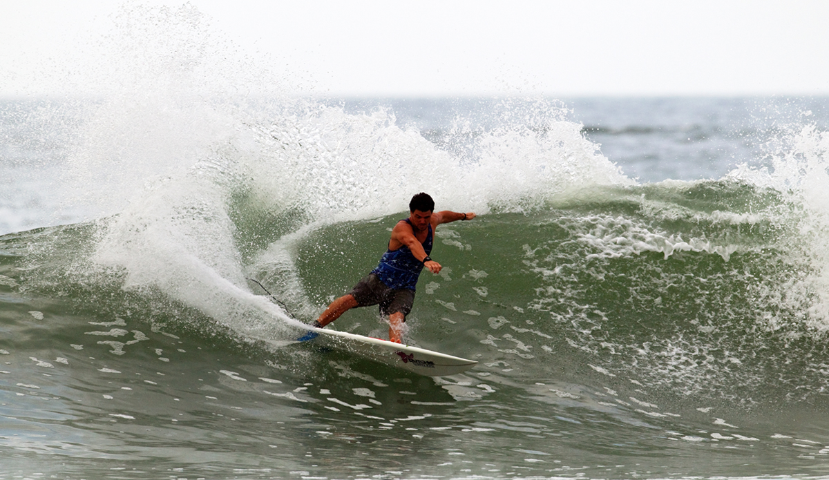 John shaking off the thought that he just walked 15 minutes through tall grass and over some dodgy terrain to go surf a spot called Black Mamba…  Photo: <a href=\"http://www.gregewingphoto.com/\"> Greg Ewing</a>