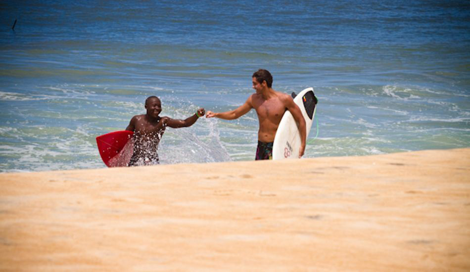 Chris Kleusner and Liberian local. Groundswell is planning trips to Center for Surf Research alumnus Sean Brody\'s Kwepuna Retreat in Robertsport Liberia for 2014/15. Photo: Sean Brody