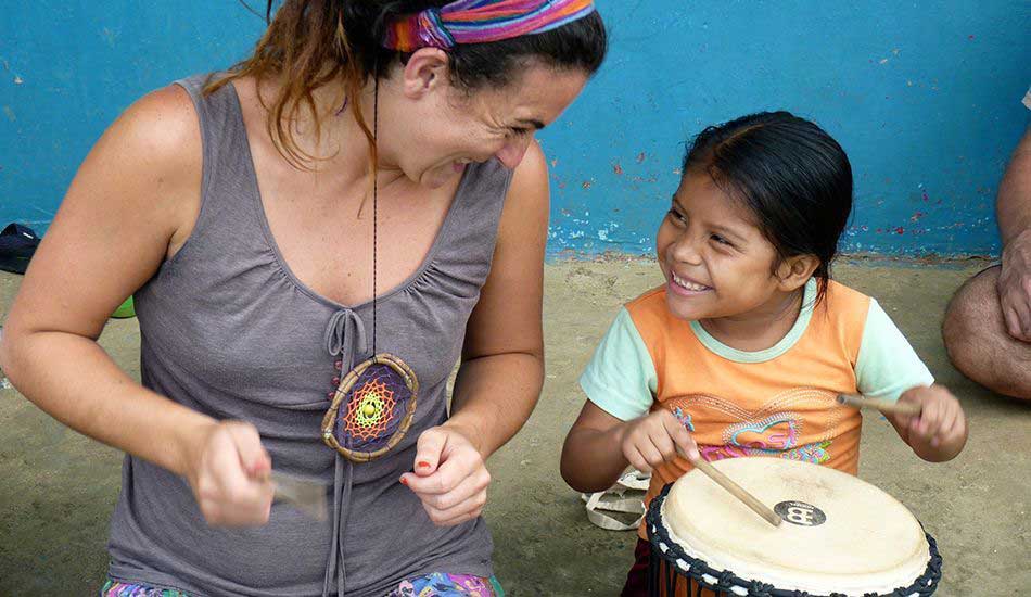 Rubiella and student drumming an afternoon beat. Photo courtesy of Groundswell Travel