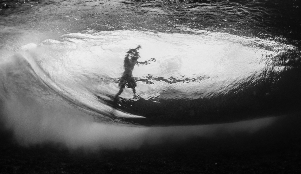 An unknown dark silhouette races the oncoming section in the Maldives. Photo: <a href=\"http://haydenoneillphoto.com/\">Hayden O\'Neill</a>