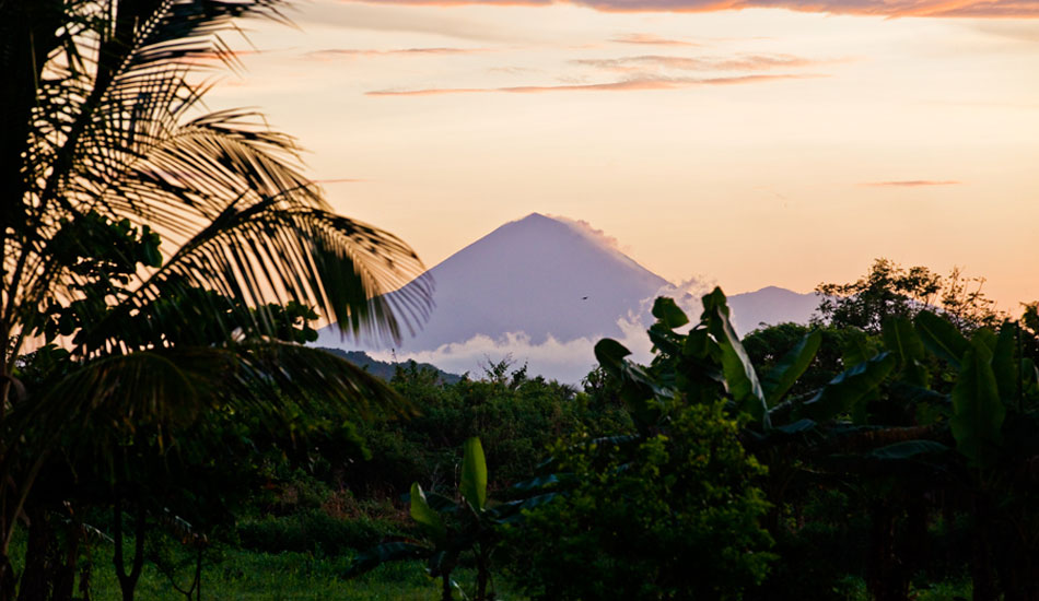 A Volcano peeks over the horizon somewhere in Central America. Photo: <a href=\"http://ryanstruck.com/\" target=_blank>Ryan Struck</a>/<a href=\"http://www.thenewsurf.com\" target=_blank>The New Surf</a>