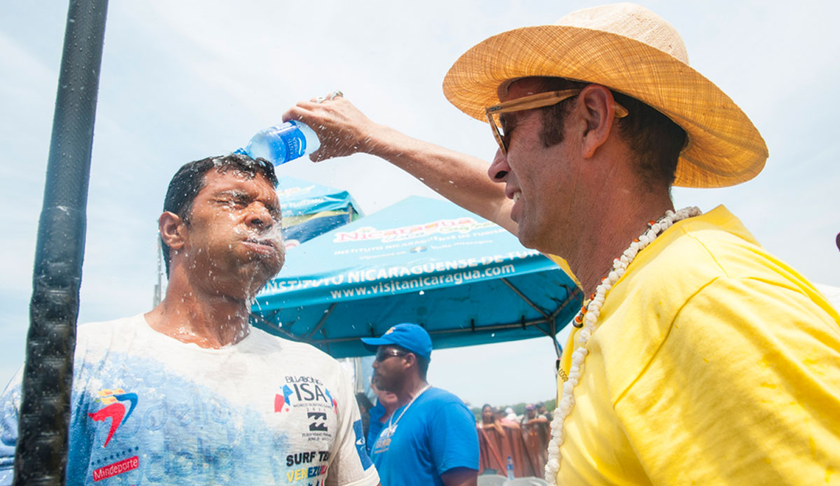 ISA President, Fernando Aguerre, douses a Venezuelan contestant. Photo: <a href=\"http://www.isasurf.org/\"> ISA | Rommel</a>