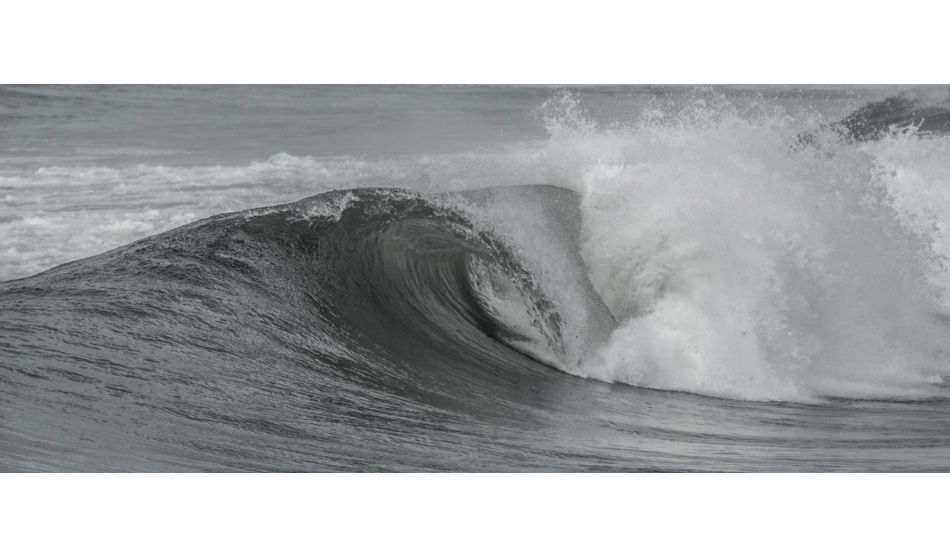 A perfect wave slips by the crowd. Sunset Cliffs, San Diego.