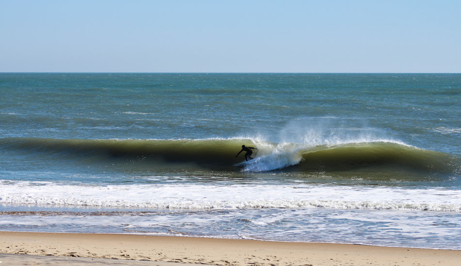 After seeing such a dramatic drop-off in size in town, it was a relief to pop over the dune to see our friend Brian Bassett (pictured here), getting some tube time. Photo: John Streit.