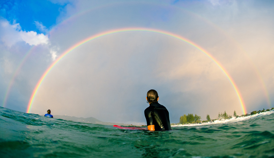 Joe Guinand sitting in awe under the most ridiculous double rainbow spanning across the Bay. Image: <a href=\"http://www.alexfrings.com\" target=\"_blank\">Frings</a>