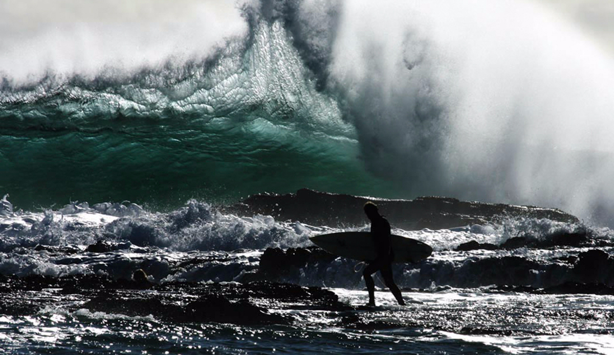 A surfer navigates his way through the rocks as backwash collides with an oncoming wave during a big swell at Snapper Rocks, QLD, Australia. Photo: <a href=\"https://instagram.com/krystlejwright/\">Krystle Wright</a>