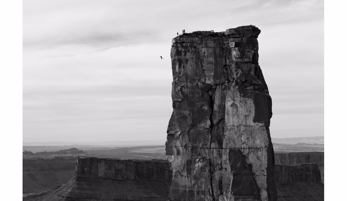 Fellow BASE jumpers look on as Michael Tomchek free falls beside Castleton Tower before opening his chute in Castle Valley, Utah. Photo: <a href=\"https://instagram.com/krystlejwright/\">Krystle Wright</a>