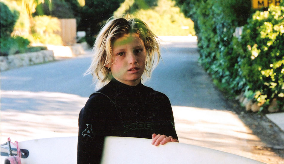 I started really getting into surfing when I was about 11 and 12. I think here I am about that age. Ready to go with my green zinc and all.