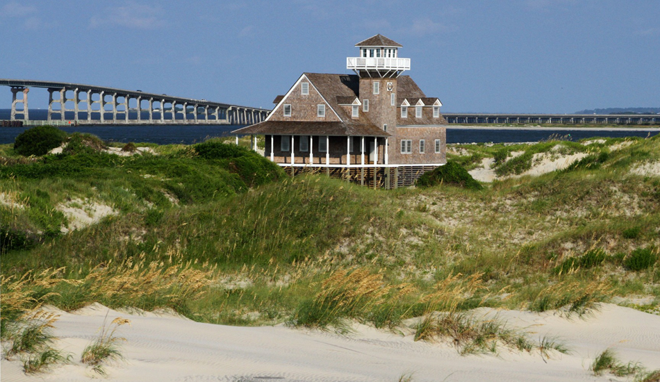 Old Coast Guard Station, Oregon Inlet. It was just refurbished after years of being abandoned. That’s the Bonner bridge in the background, the true gateway to Outer Banks surfing. Image: McCarthy