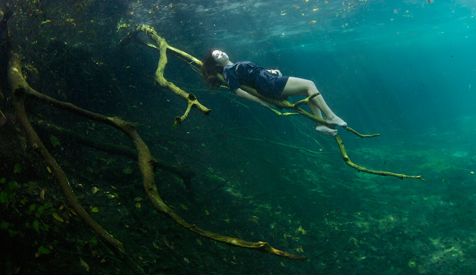 Freediver Camila Jaber resting on a tree branch in Car Wash. Photo: <a href=\"http://liabarrettphotography.com/\" target=_blank>Lia Barrett</a>