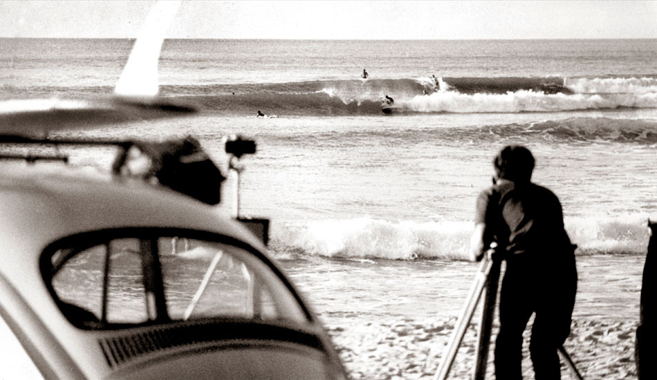 Noosa Heads, First Point 1967 - Taken from the car park at first point on a trip to Noosa Heads in late autumn or early winter. My white 1960 VW, standard is on the LHS of the image and framed in the back window are the legs and   board of a surfer on the shore break.   Andy McAlpine is behind the timber tripod filming Children of the Sun. Photo: <a href=\" www.bruceusher.com.au\">Bruce Usher</a>    