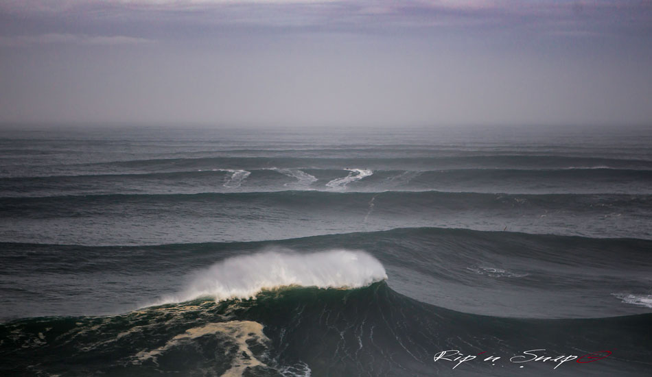 Jet Skis in the back look small because it was shot approximately 150-200 meters over the ocean from the roof of the Nazaré Lighthouse. Photo: <a href=\"https://www.facebook.com/ripandsnap\" target=_blank>Mark Wengler</a>