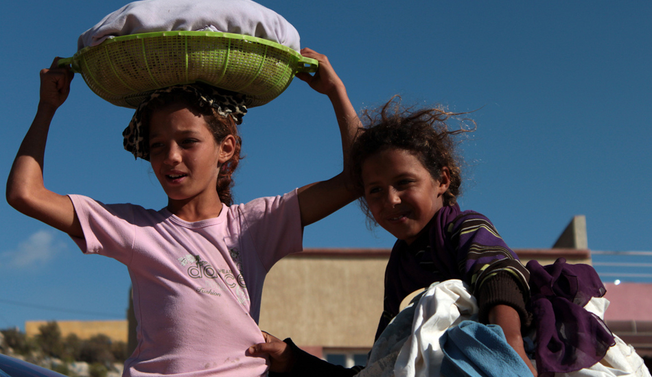 <strong>Morocco.</strong> Local girls. We stopped at some random place on the road. I am sure the locals there do not see too many visitors. There were a few kids around, and they suddenly come to see us. They didn’t ask for moneys but instead for some pens. Image: Sbrizzi