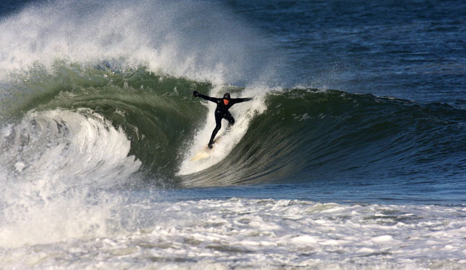 Chris Hunter-The backwash at high tide gave Chris Hunter a bit of a surprise drop. Mirlo Beach, Rodanthe.  Photo: Mickey McCarthy.