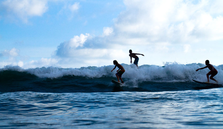 It\'s not all about cutthroat competition down there. Some times it\'s about party waves! Photo: <a href=\"http://www.jungphoto.com/\" target=_blank>Justin Jung</a>