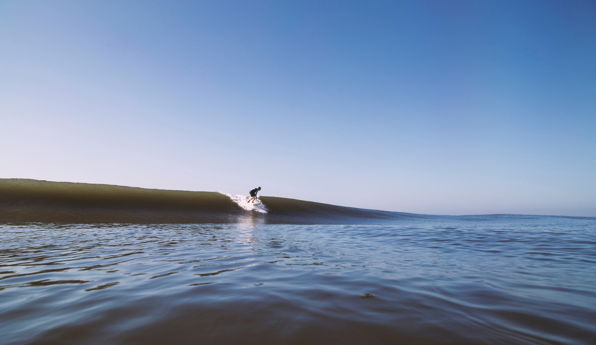 The foreign surfer, some would say he’s lucky, other’s might say he’s mad. Photo: <a href=\"http://www.kheperphoto.com/\">Paola Núñez Linares</a>