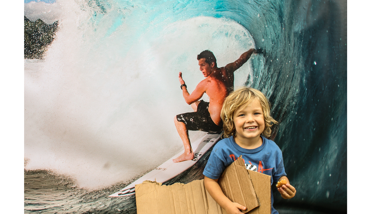 Axel stopping for a split second to pose with a poster of his father. Photo: <a href=\"http://www.danegrady.com/\">Dane Grady</a>