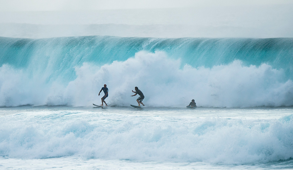 Kelly Slater, on the left, came screaming out of this barrel to meet the two on the right as they exited their wave. Photo: <a href=\"http://www.joliphotos.com/\">Peter Joli Wilson</a>