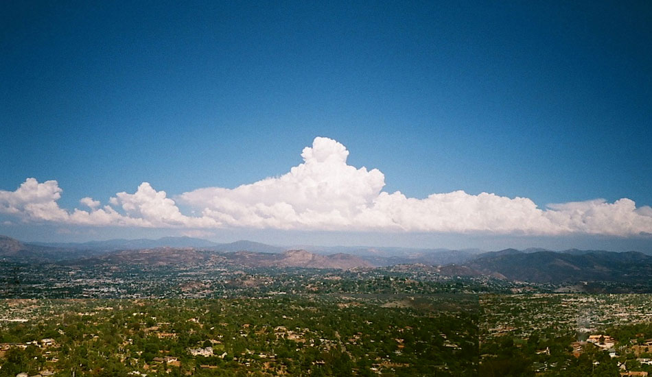 August was a rough one this year in San Diego; the surf was flat for a month and it was really, really hot. The tropical weather made for some unreal clouds though, and I couldn\'t resist driving to the top of Mt. Helix on my way home from work one day to get a capture of them. Minolta TC-1, fuji superia 200 film. Photo: <a href=\"http://fotoburns.com\">Adam Burns</a>