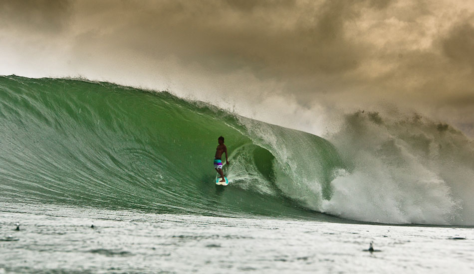 The waves were pumping on this trip, but the weather was overcast and raining a lot. Here is Dedi Gun, one of Indo\'s funniest free surfers. Photo: Brad Masters