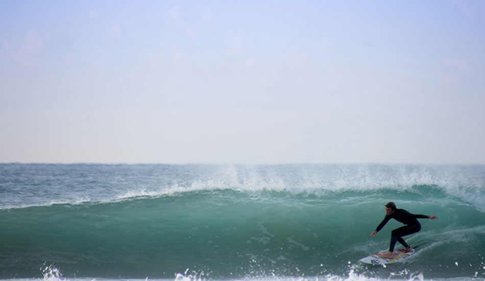 Ryan Hunt rolls through the wave, eventually exiting the wall. Photo: <a href=\"http://www.twhyphotography.com\">Tyhe Reading</a>