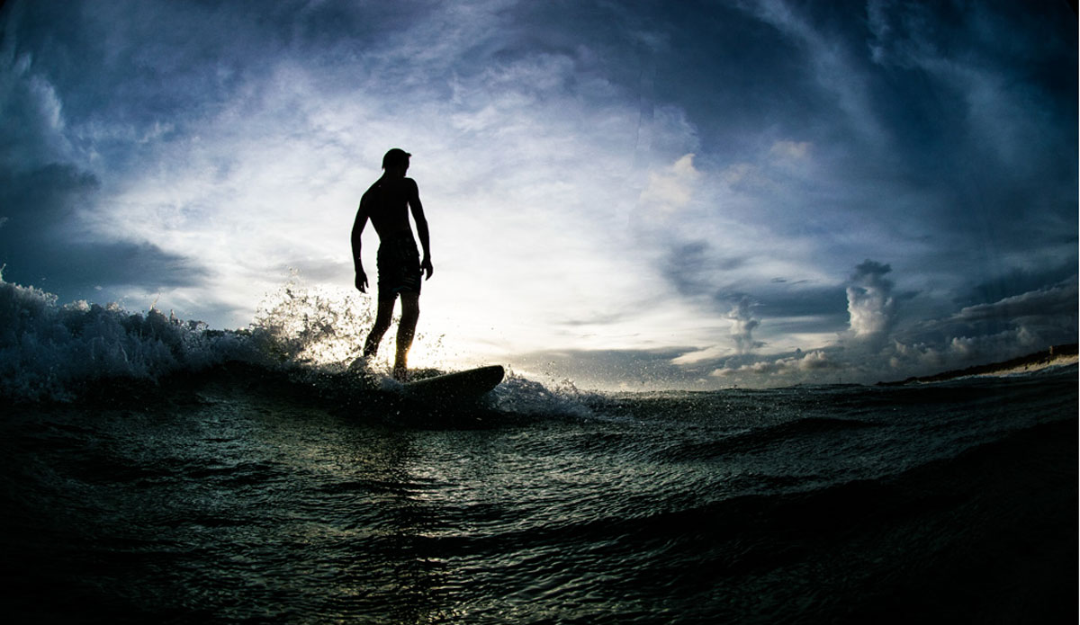 James Overman standing tall, silhouetted in front of the setting sun. Photo: <a href=\"https://richbrooksphotography.squarespace.com/\"> Rich Brooks</a>