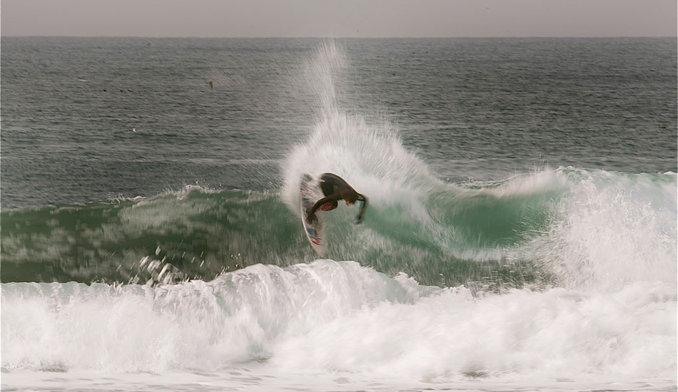 Pat Curren seemed oblivious to the fact a guy just got bumped off his board by a shark and to why everyone was getting out. Photo: Robb Wilson