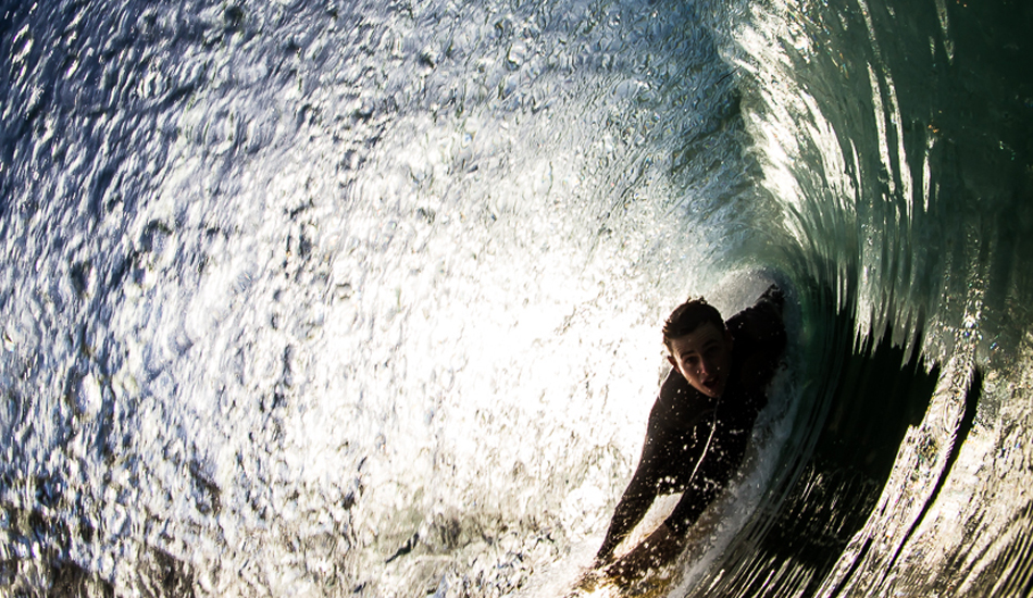 Bryan Timm pulls into a full barrel on New Year\'s Day 2014 in North County. Photo: <a href=\"http://www.surfingeye.com/\" target=_blank>Ronald Hons</a>.