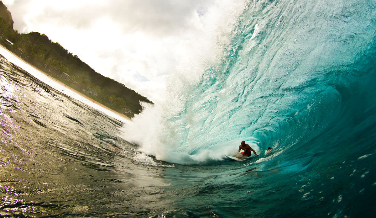 Shane Dorian from the Banzai in 2012. It\'s obviously not the gnar shot everyone one is after from Hawaii, but it represents more of the scene there for me. I decided I had to go to Hawaii at least once and why not during the Superbowl of surfing. This was the morning that Pipemasters started and all da boys were out. It was so incredible to see everyone surfing so well. It was even more magical to feel Pipe break. There\'s really no other way to describe that wave. I\'m getting psyched just thinking about it, picturing it bend, feeling its pull. As you can see, there\'s another camera in the frame. I believe that\'s Jeff Flindt and another photog on the inside ducking under this one. So nothing nuts here, but everyone\'s intro to Hawaii is a milestone. I haven\'t been back yet but the thought of Pupukea Grill alone is plenty enticing. Photo: <a href=\"http://www.ryanstruck.com/\"> Ryan Struck</a>